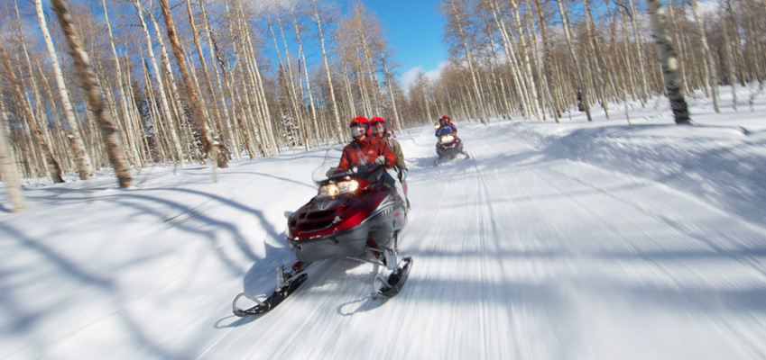 Friends Riding Snowmobiles Safely