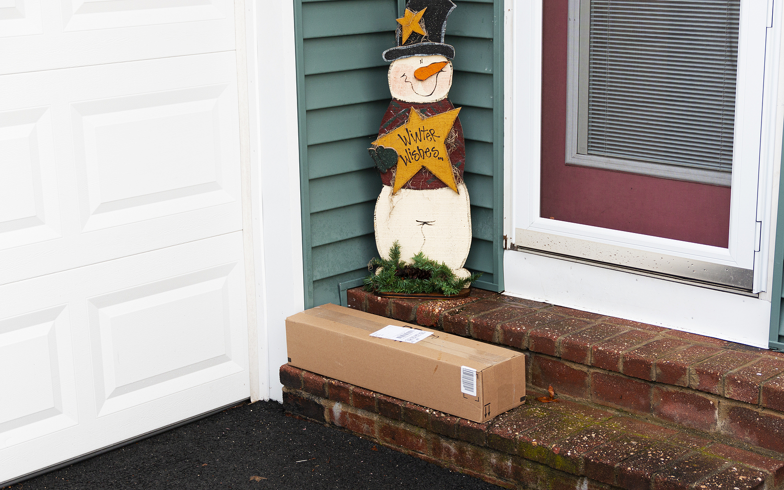 A Package Is Left By The Side Door O A Residential House In Dece