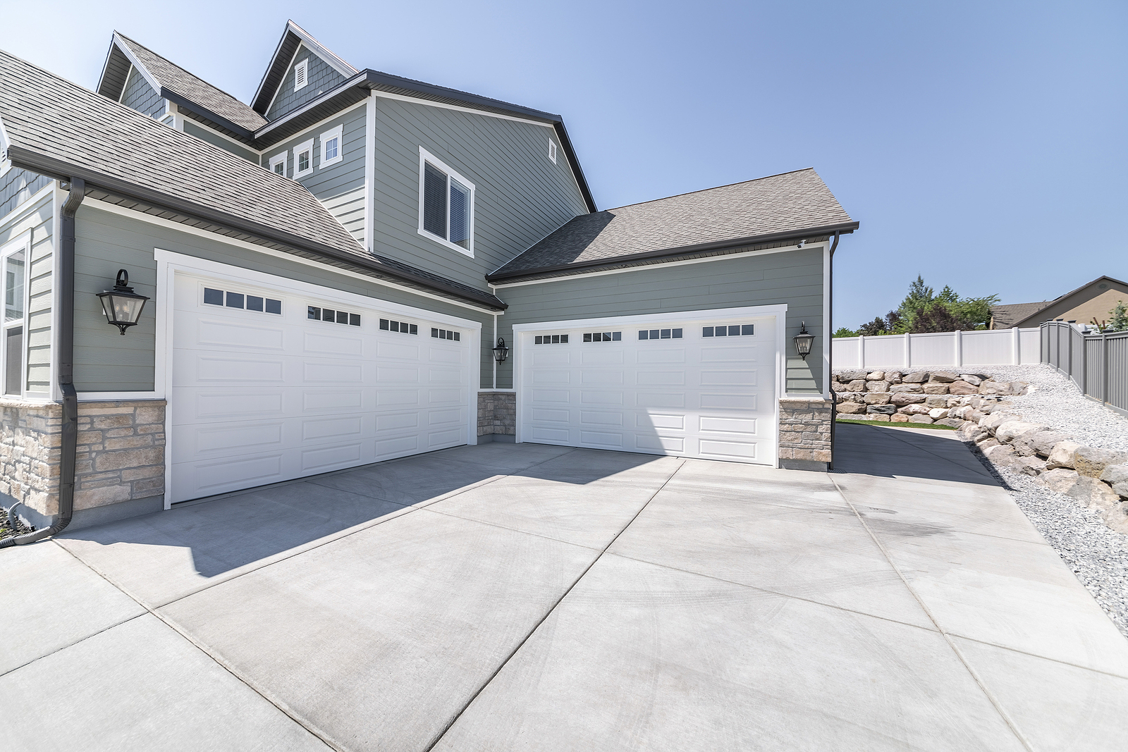 Exterior Of A House With Concrete Driveway And Two Closed White