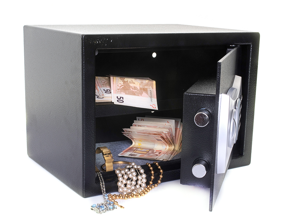 strong box with cash and jewlery in front of white background