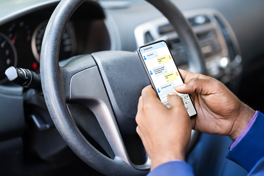 Distracted Man Texting On Mobile Phone While Driving