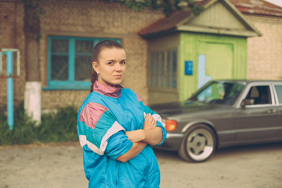 The girl in the nineties. On the background of old car