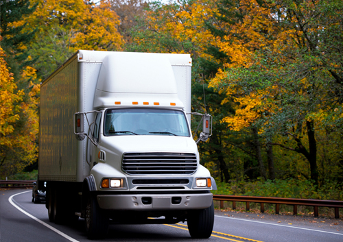 Commercial Truck Driving Down Road